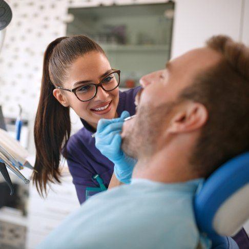 Dentistry team member treating dental patient