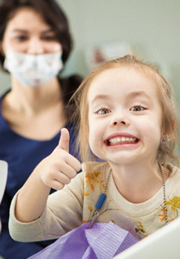 Child smiling in the dental chair