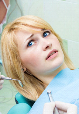 Woman afraid in the dental chair