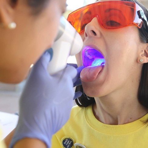 Dentist performing oral cancer screening