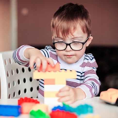 Child playing with block after special needs dentistry visit