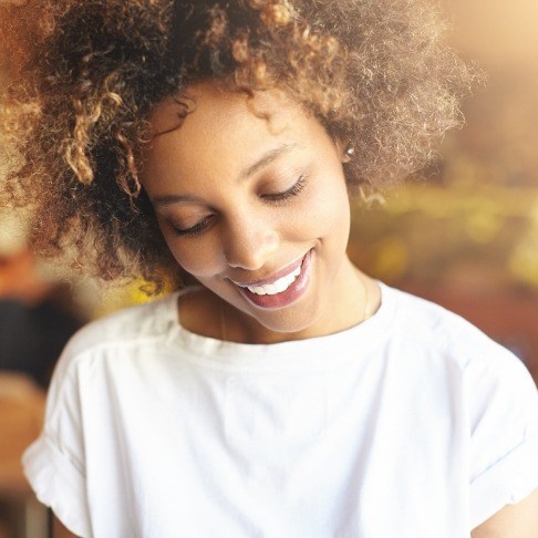 Woman sharing flawless smile after gummy smile reduction