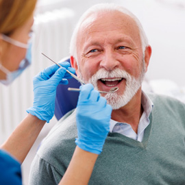 Man smiles at dentist