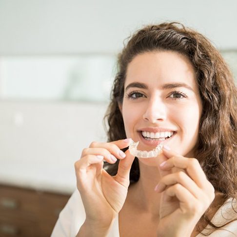 Woman smiling after wearing Invisalign in Deerfield
