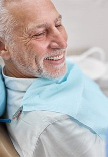 a patient smiling while getting restorative dental care