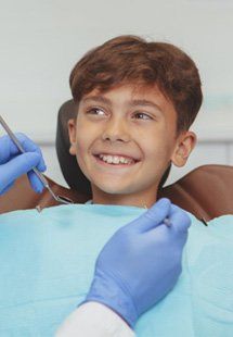 a child smiling after getting dental treatment near Highland Park