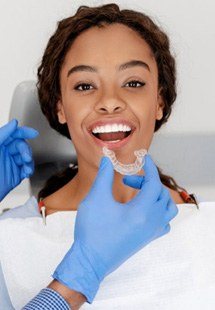 a patient receiving her Invisalign aligners near Highland Park