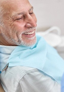 a patient smiling while getting restorative dental care