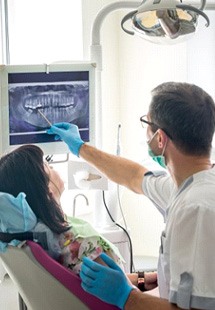 a dentist presenting an X-ray to a patient