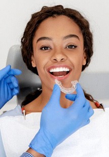 a patient receiving her Invisalign aligners