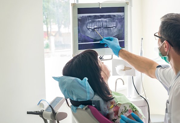 Dentist and dental patient looking at digital x rays