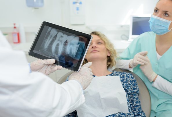 Dentist talking to dental patient